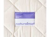 Organic-kids-mattress-closeup-of-naturalmat-label-on-quilted-cotton-cover-in-Ivory-color-made-by-NaturalMat-sold-by-Huckleberry-Kids-Rooms